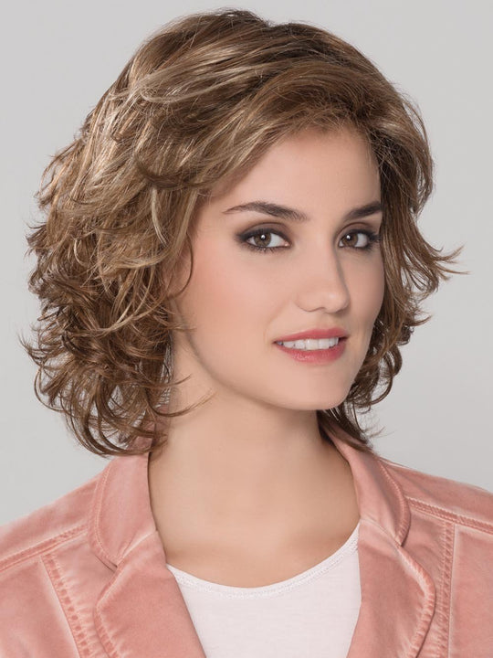 A shoulder length style full of soft waves all over, and a wispy bang